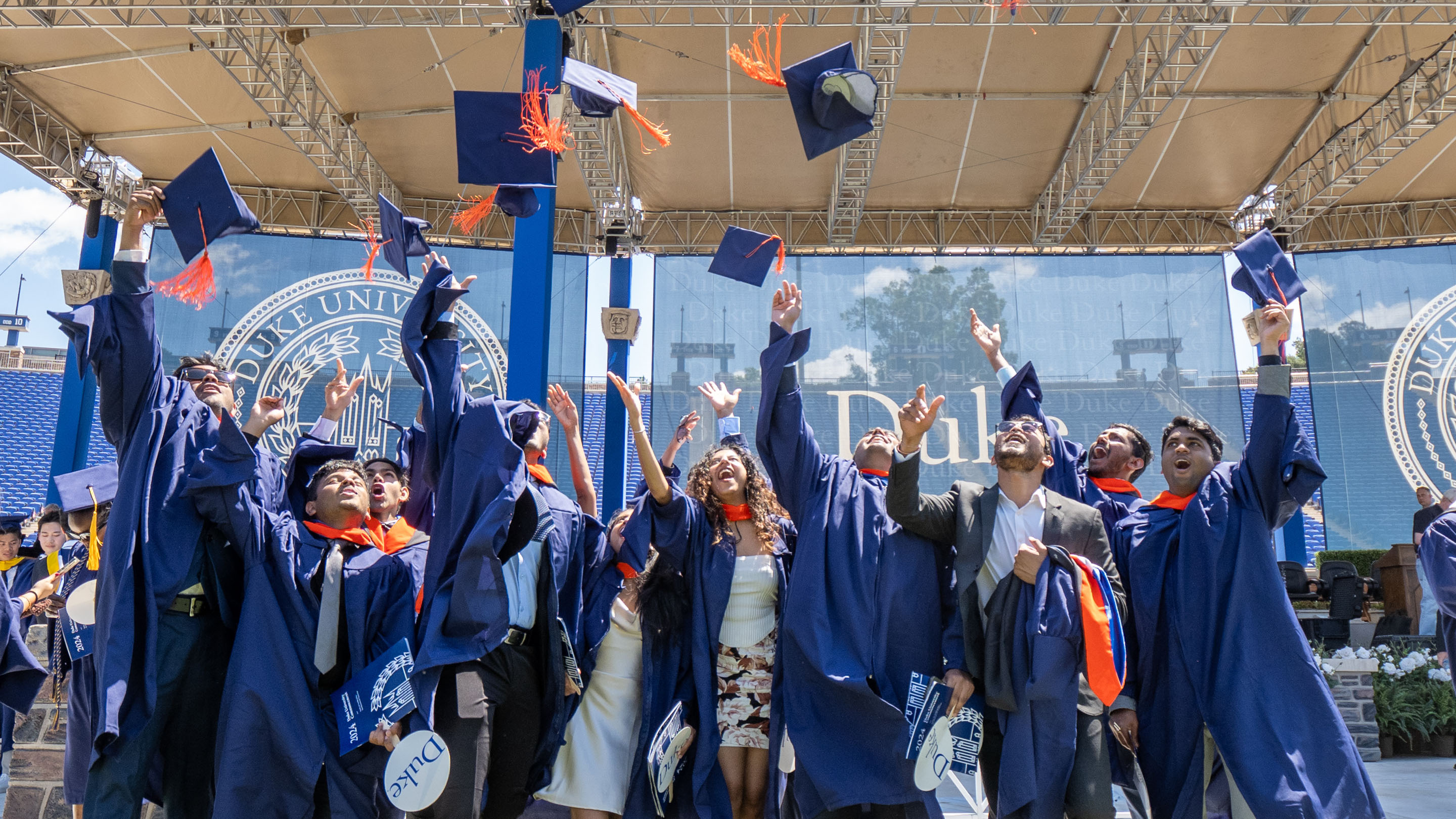 Graduates throwing their caps in the air at graduation