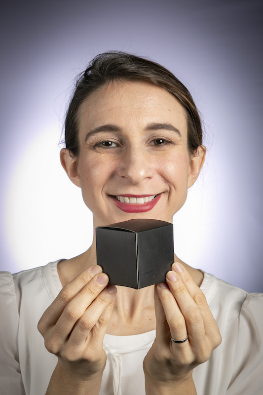 Cynthia Rudin smiling with a black box
