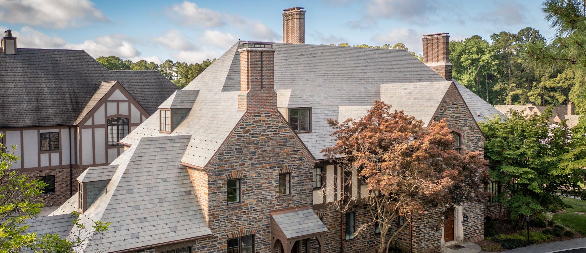 A brown and grey stone building on Duke University's campus where the Graduate School offices are located