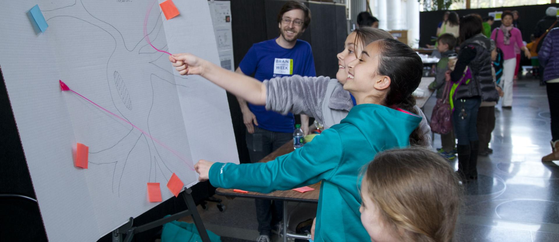 Schoolchildren play "prune the neuron," an activity at Duke University's Brain Week.