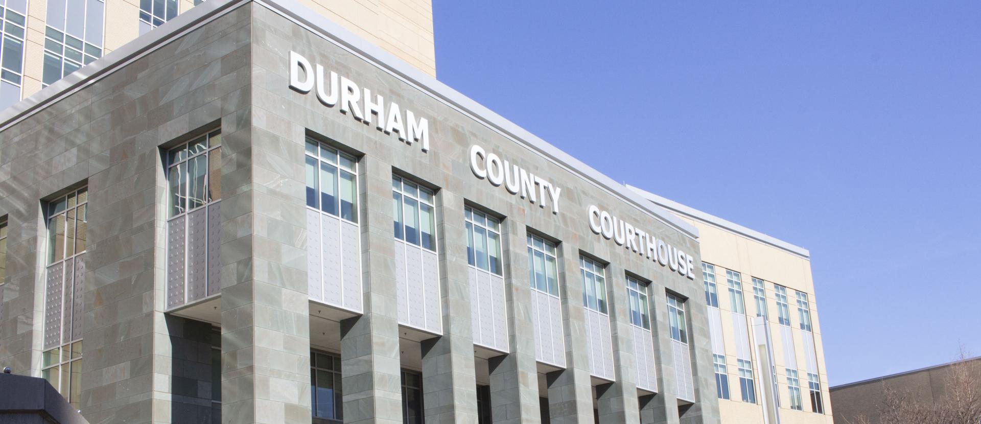 Portrait of the Durham County Courthouse set against a blue sky.