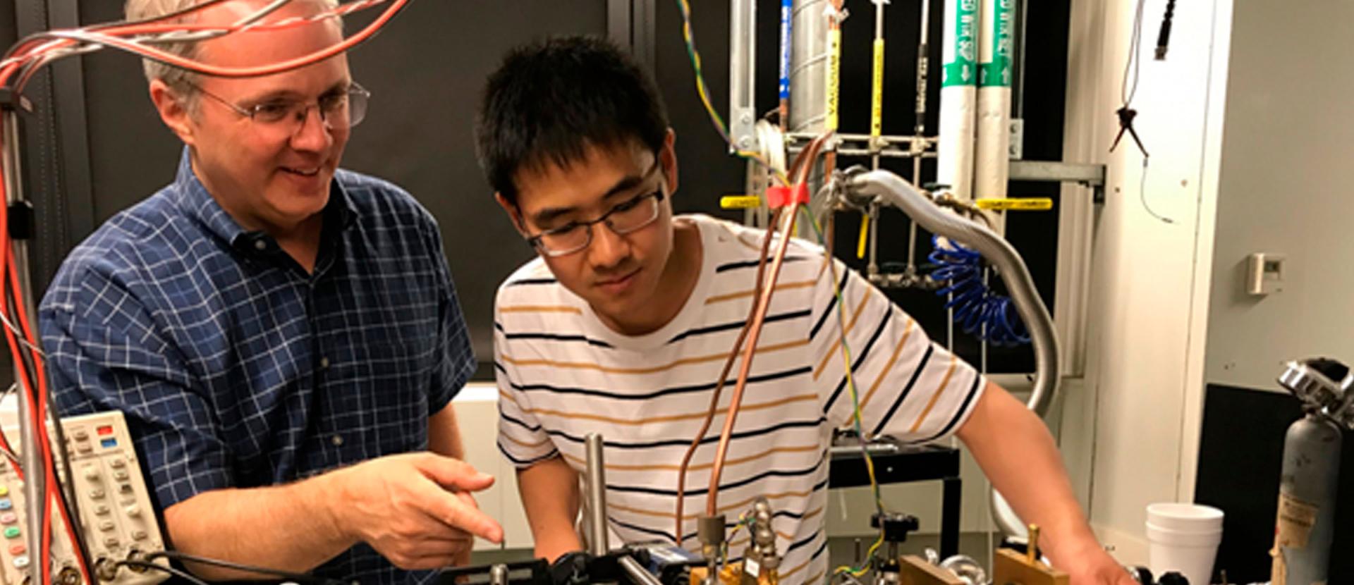 A Duke professor helping a Duke student with an electrical/engineering project.