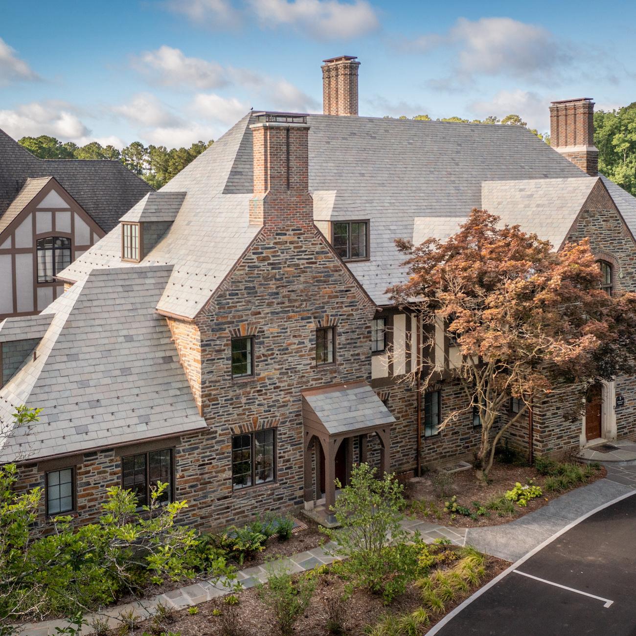 A brown and grey stone building on Duke University's campus where the Graduate School offices are located