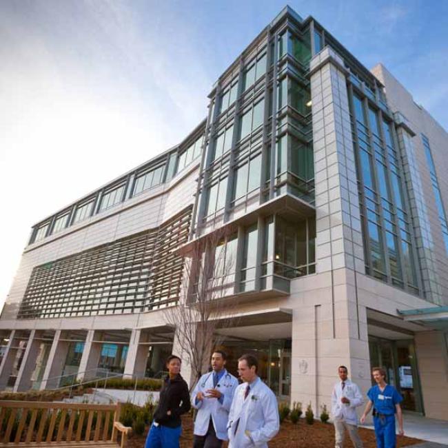 Hospital staff walking out of a building. 